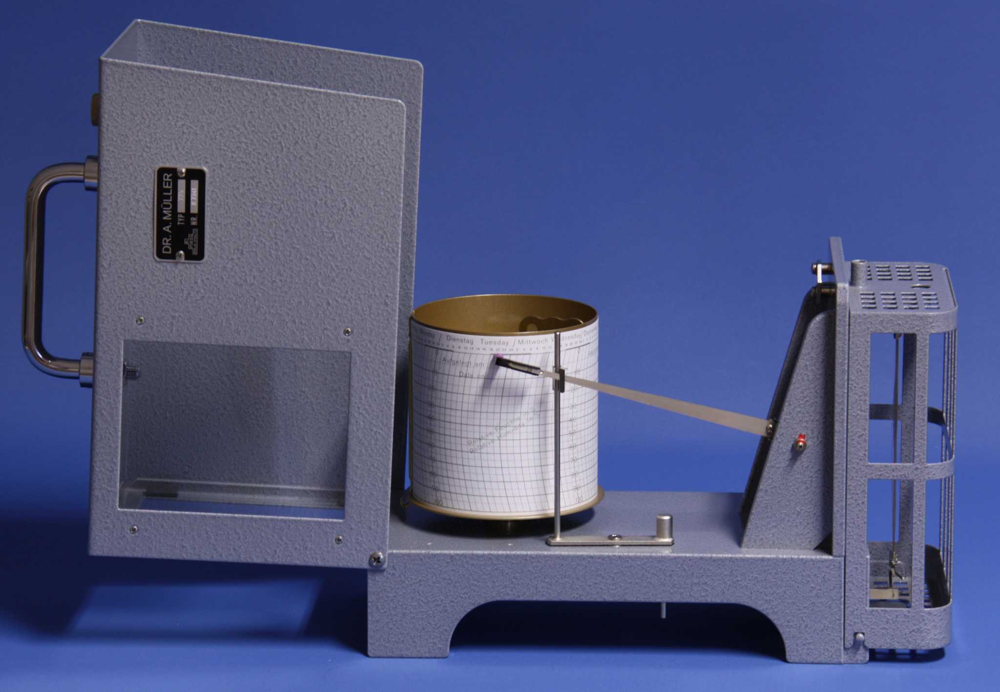 Hygrograph for measuring humidity with rotating paper drum and writing arm.