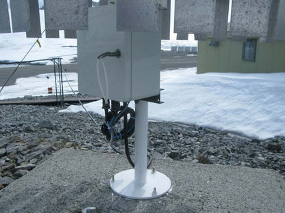 Automatischer Regenmesser UPG mit Kippwaage und robustem Aluminiumgehäuse auf Betonfläche.